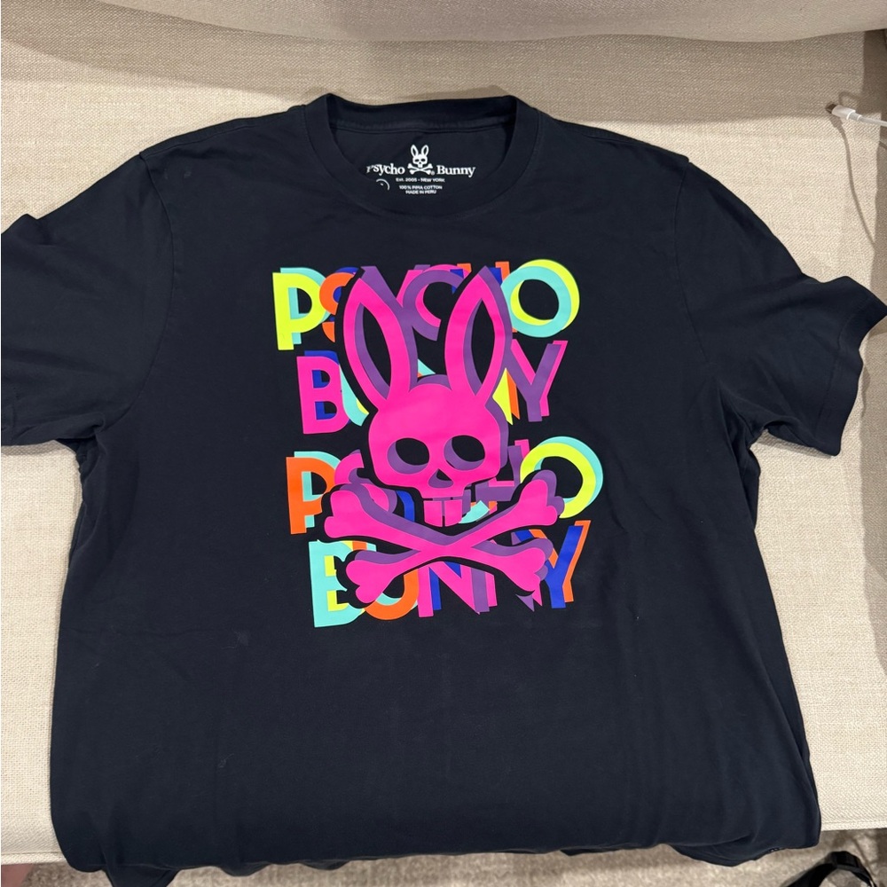 Psycho Bunny Black Tee with Neon Pink Graphic. Small stain circled in white